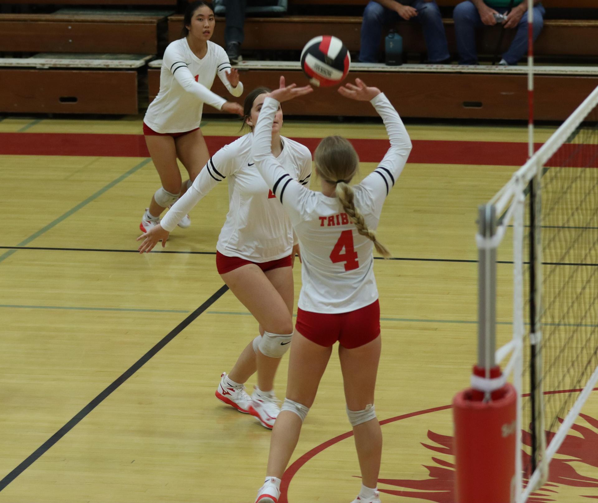 varsity volleyball players in action against liberty