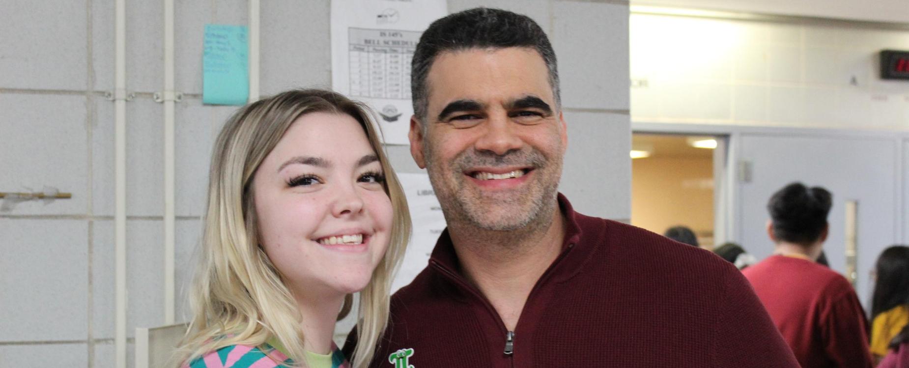 Female teacher in stripe shirt with male assistant principal