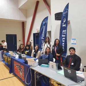 PUSD staff and school representatives welcome families at registration tables during the Kinder Round-Up event.