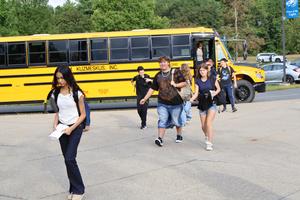Another bus unloads freshmen on the first day of school.