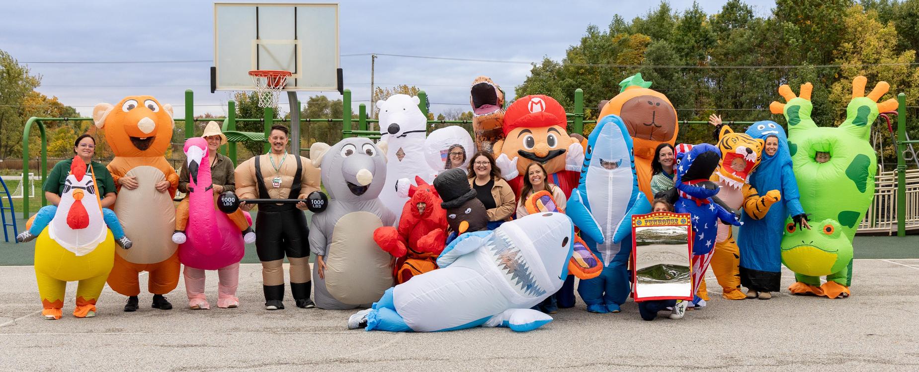 Cooks Corners Elementary School teachers pose in giant inflatable costumes.