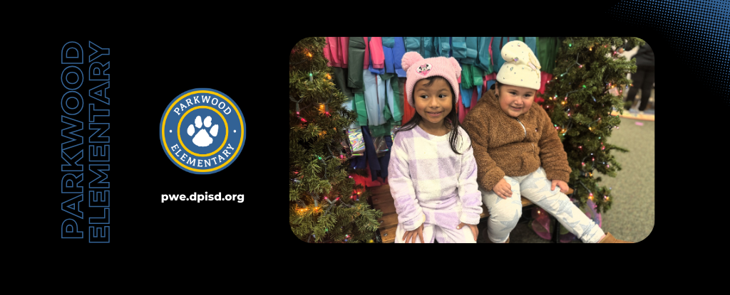 Two girls wearing winter hats sitting by decorated trees in a festive setting.