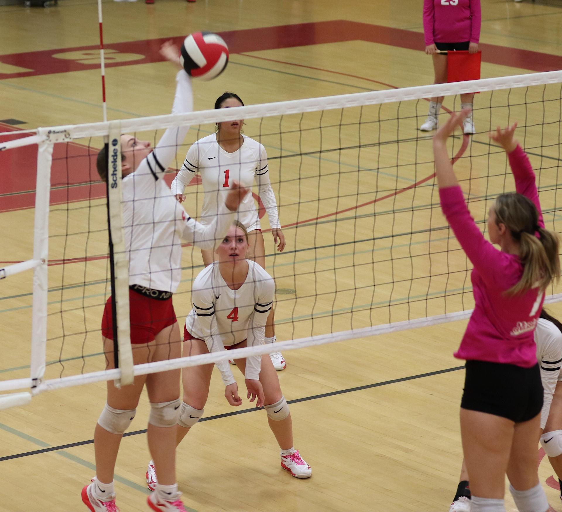varsity volleyball players in action against Minarets