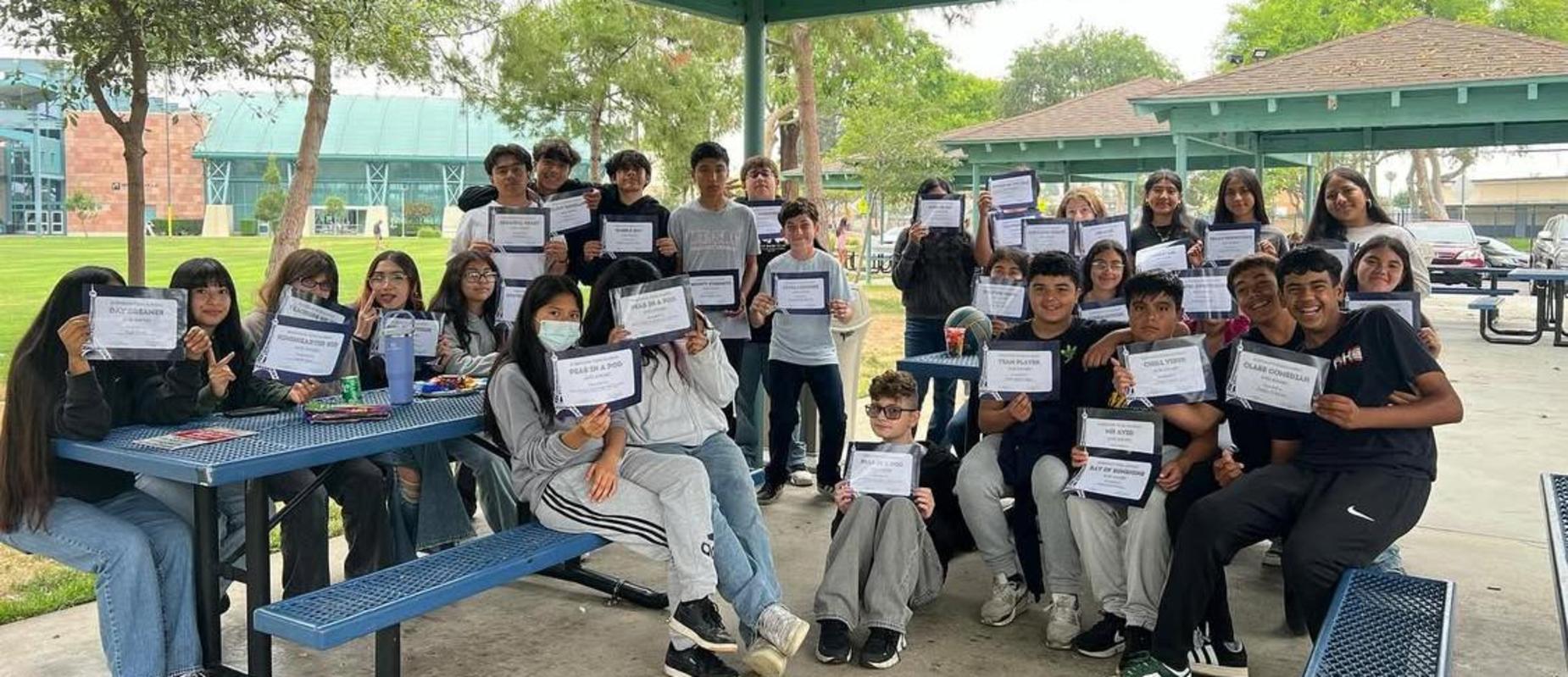 students showing off their awards