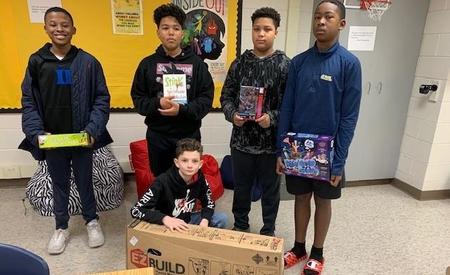 studnets holding gifts in group photo