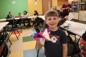 A student shows off an art project