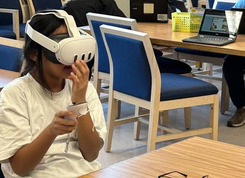 Student using virtual reality headset.
