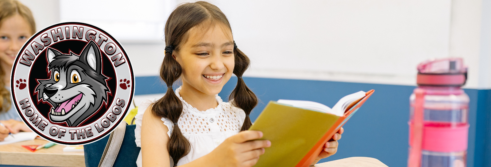 Washington ES shuffle image for homepage - students sitting at a desk smiling