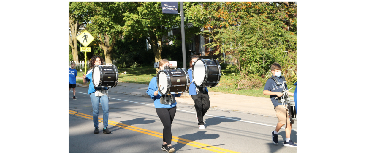 students marching while playing drums