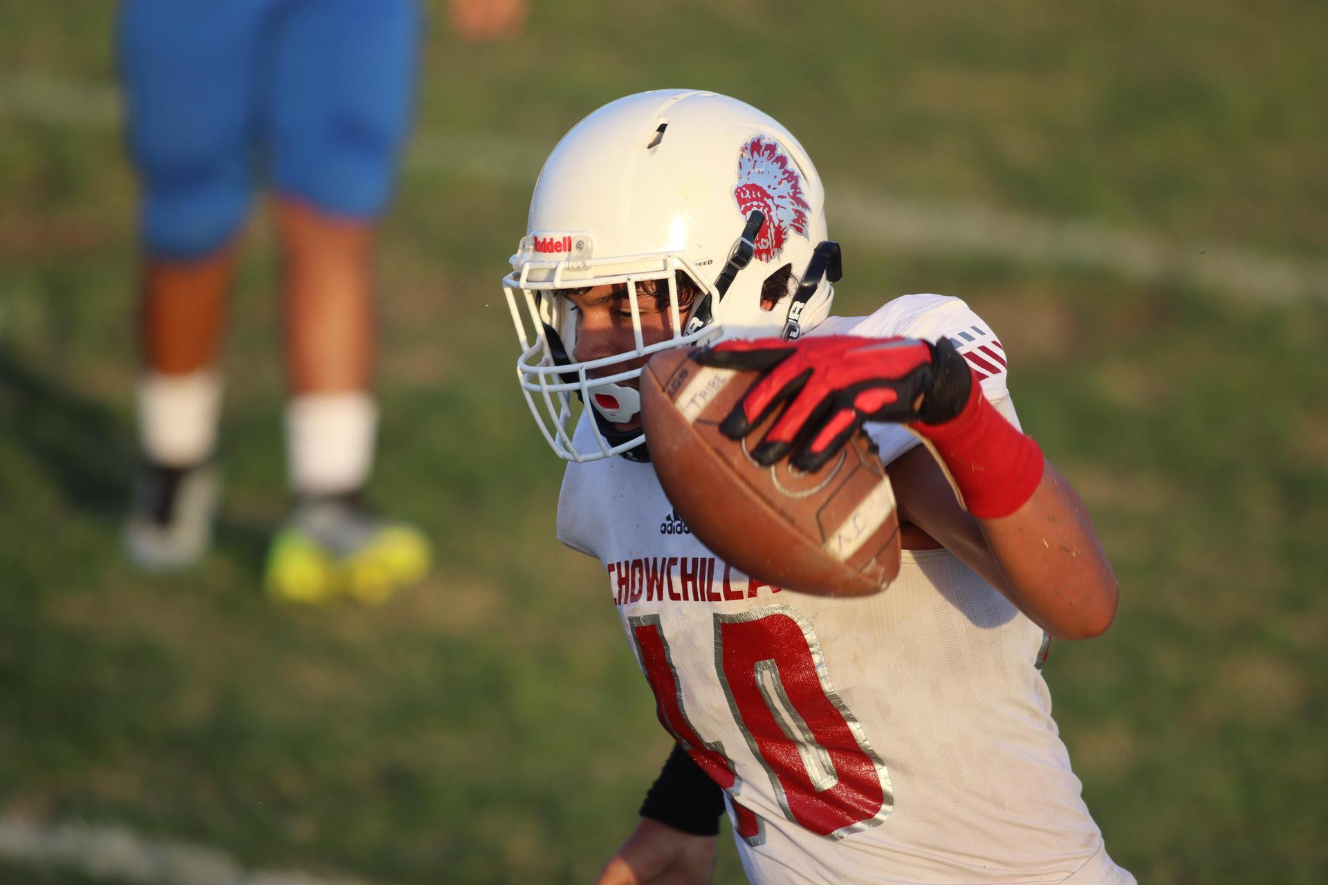 Junior Varsity football players in action against Caruthers