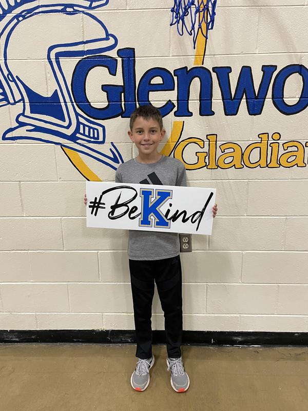 Keller holding sign