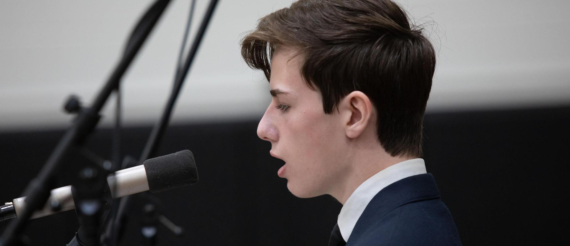 Student singing at Mass