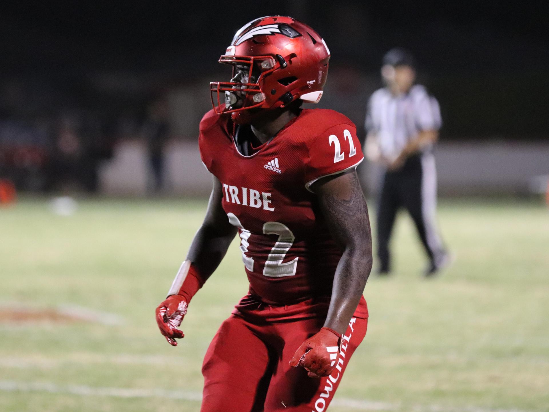 varsity football players in action against Riverdale