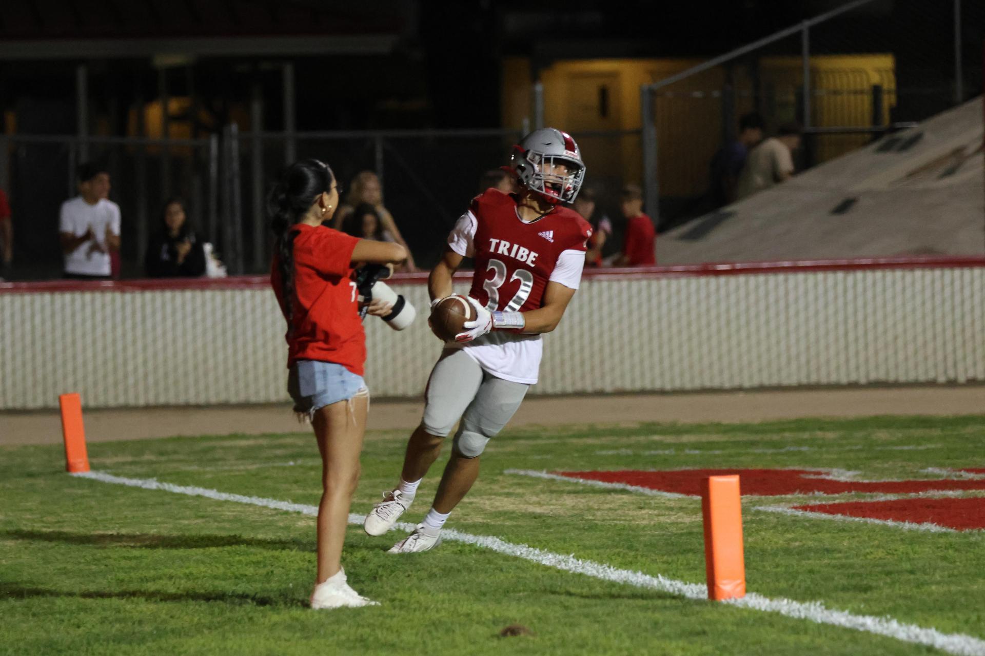 Varsity football players in action against Parlier 92
