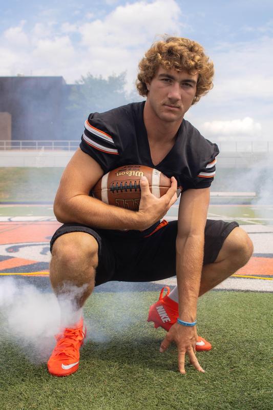 A football player kneeling in a photo taken by senior Cayla Brouwer.