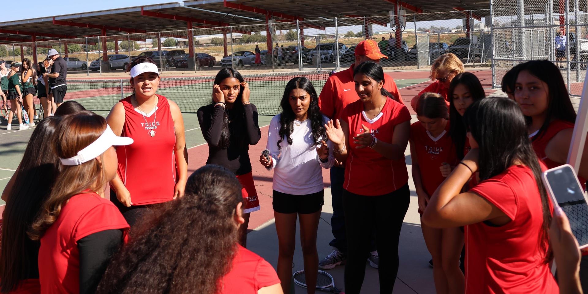tennis players, family, and staff celebrating senior night