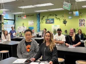 Parents sitting at desks in Albany Middle School Classroom