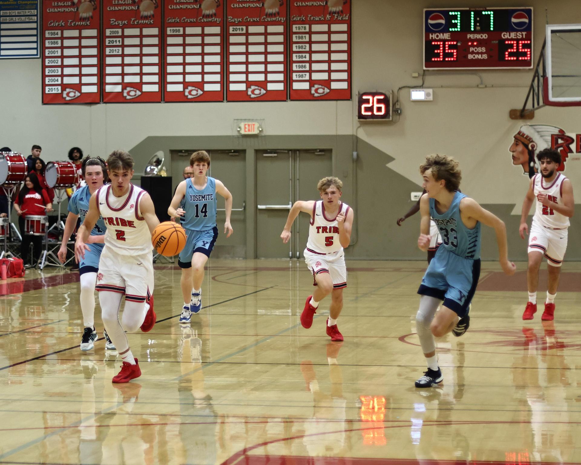 Varsity boys playing basketball against yosemite