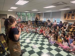 fire fighter talks to students for fire prevention day