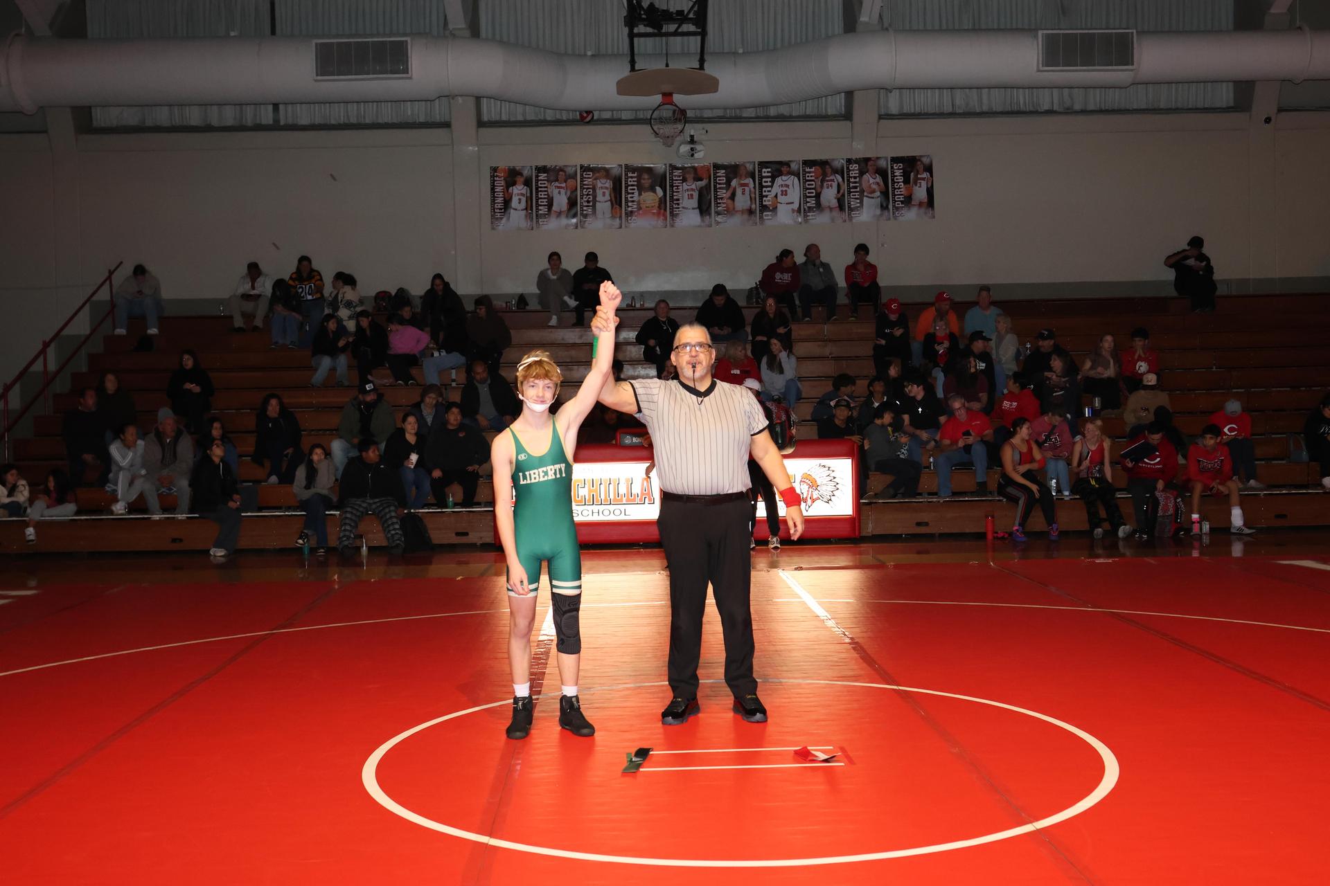 Wrestling winners with hands up 57