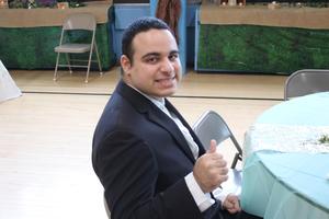 Young man in a suit giving a thumb's up