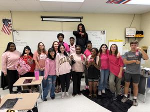 Students in pink stand with Ms. Elzie