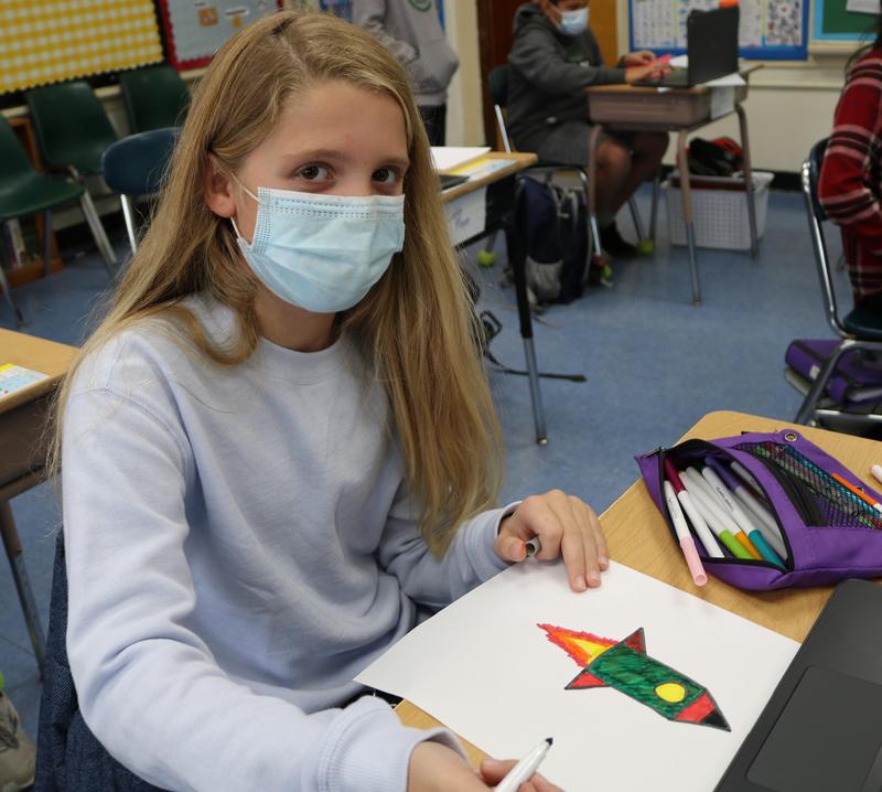 Wilson 5th grader Alexandra Benke illustrates a card for Wilson alumnus Jared Isaacman.
