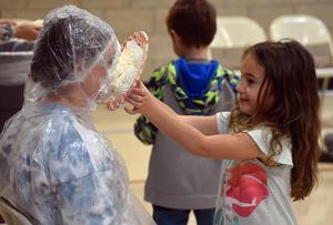 a student tossing a pie into a teacher's face