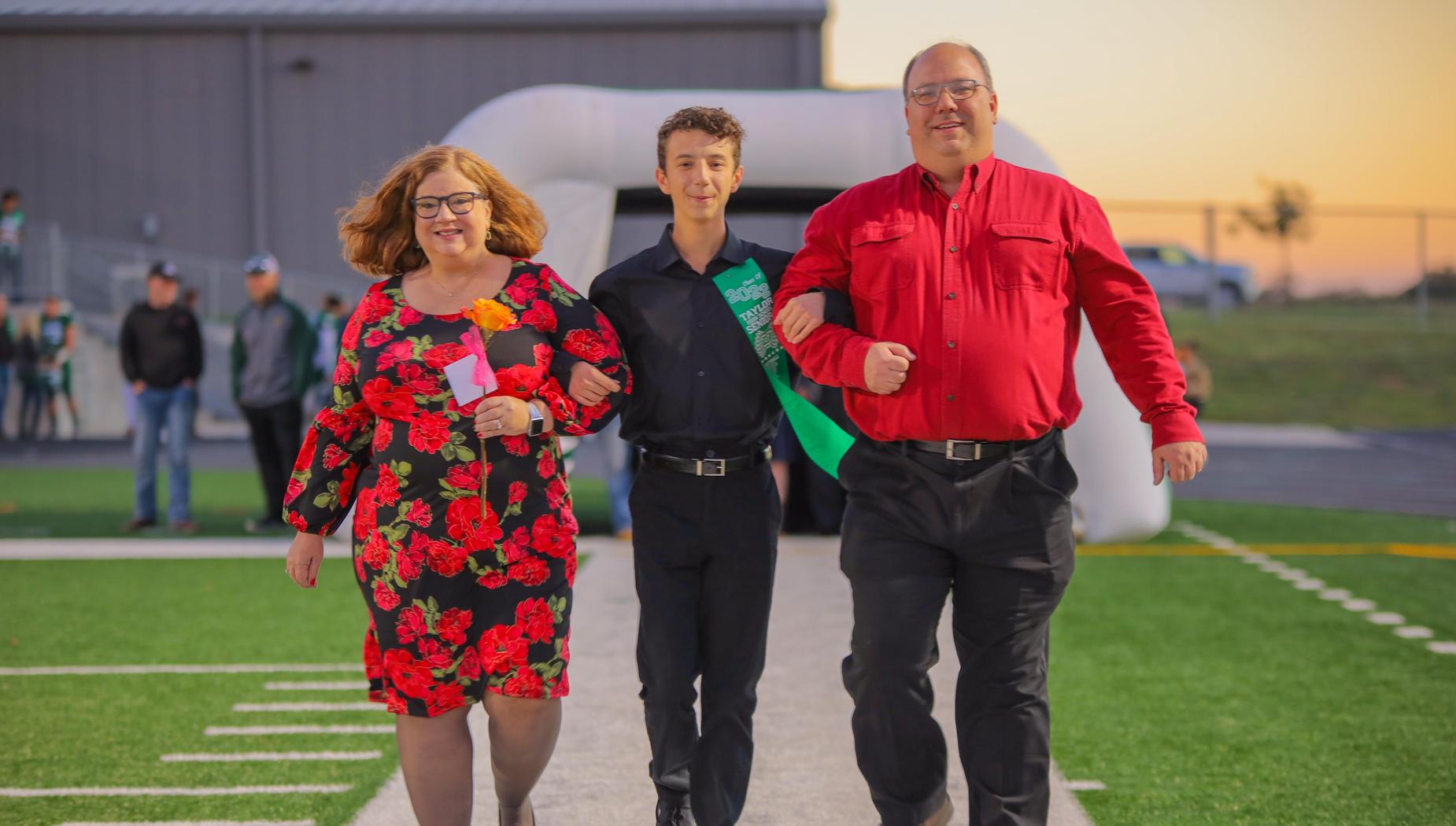 Senior escorted by parents