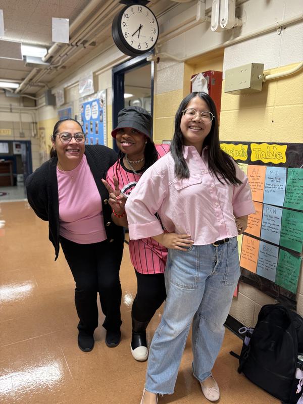 Staff smiling and wearing pink