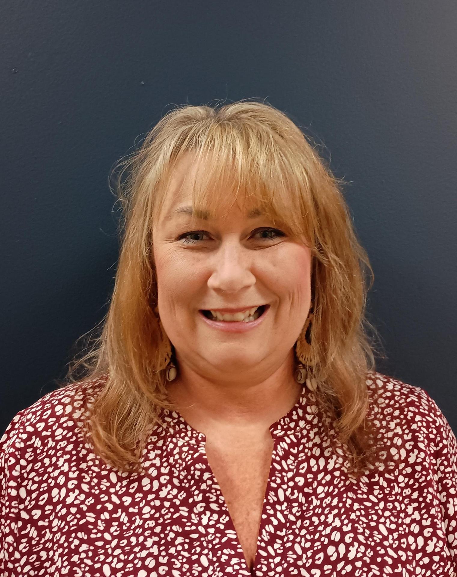 Brandi Higginbottom, Success Counselor, smiling with a colorful background.