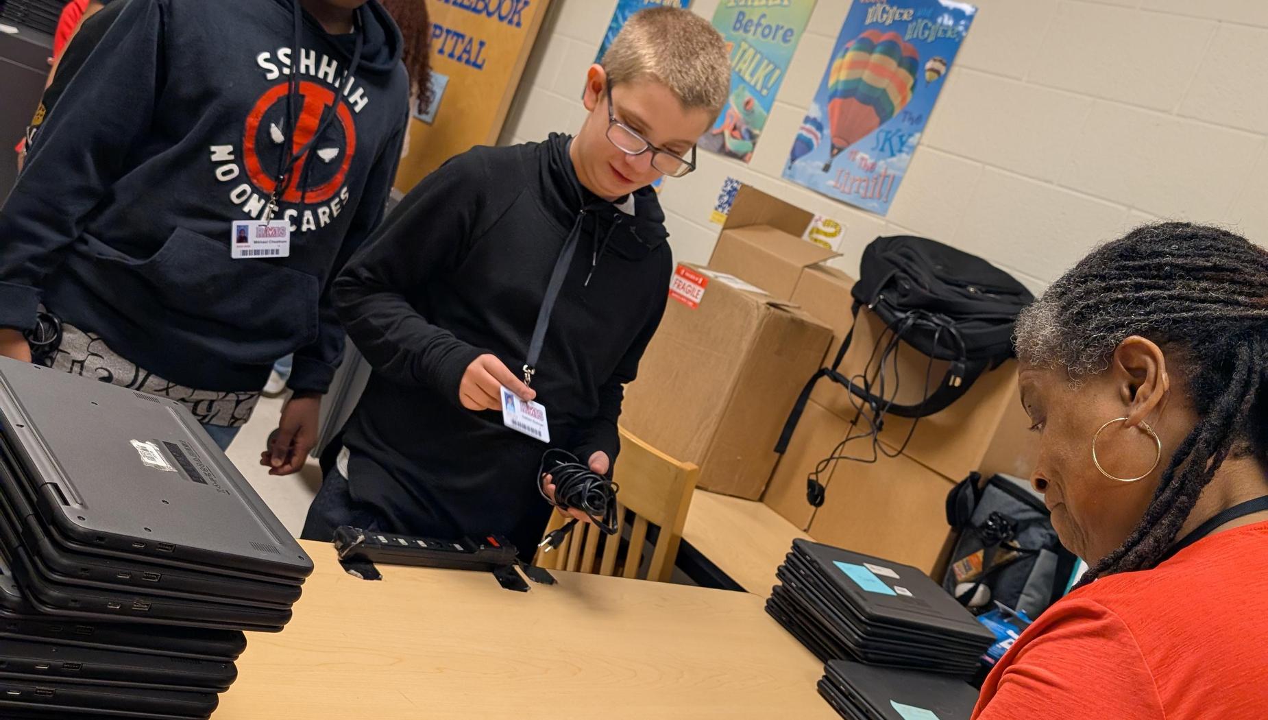 Ms. Garner distributing chromebooks