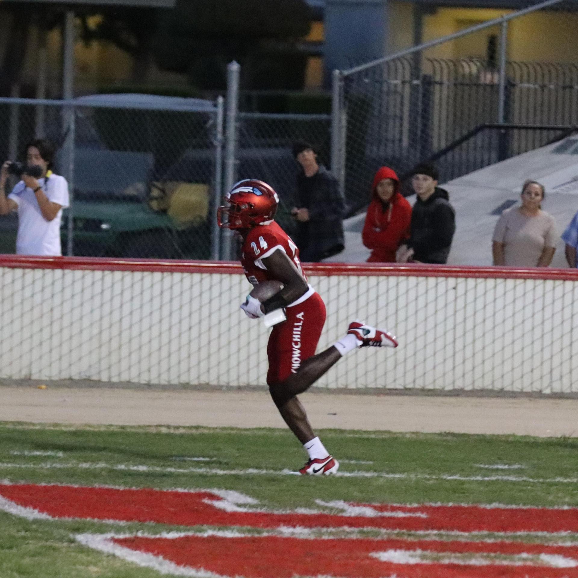 varsity football players in action against Riverdale