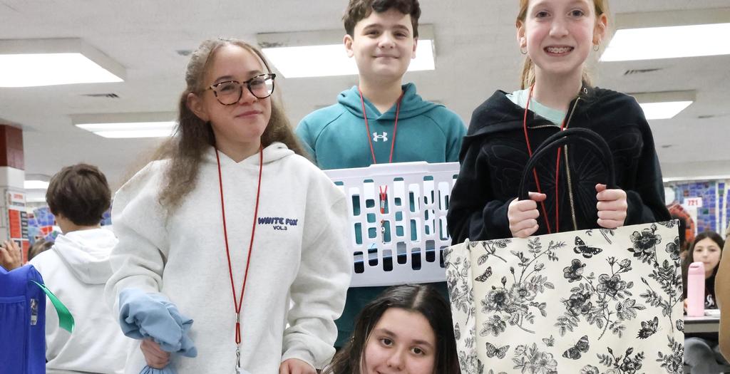 Four students standing in the cafeteria.