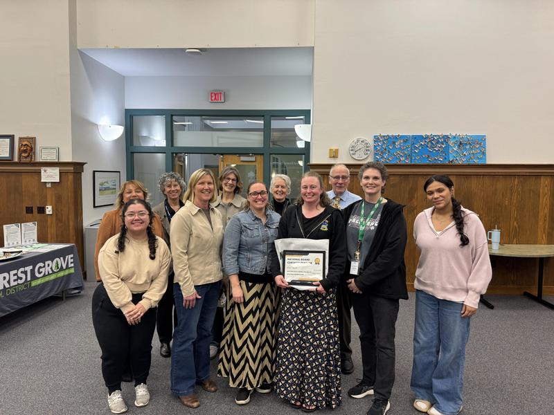Staff gathered with School Board members for a group photo