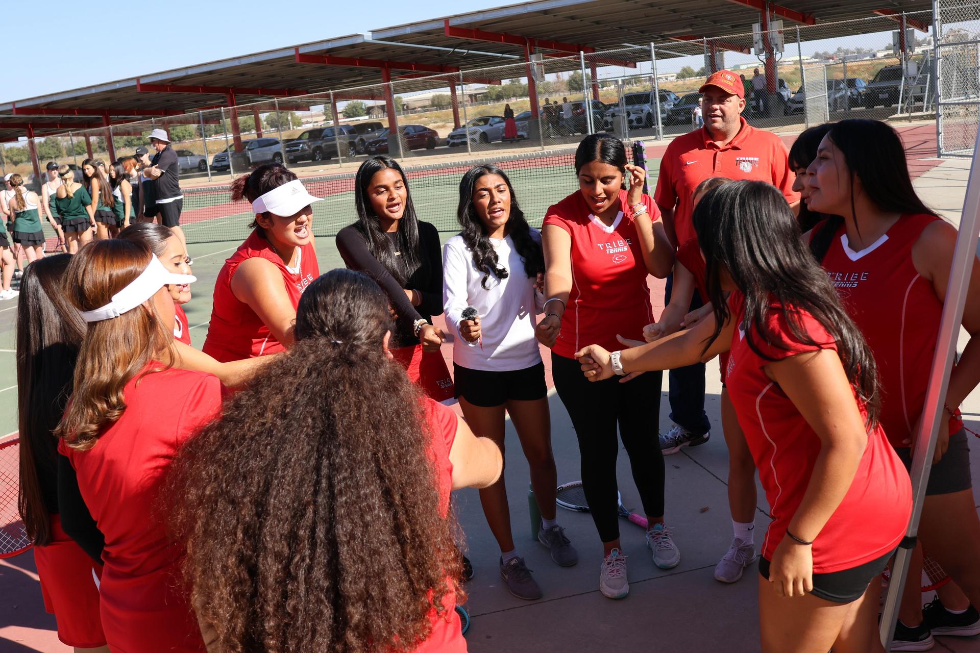 tennis players, family, and staff celebrating senior night