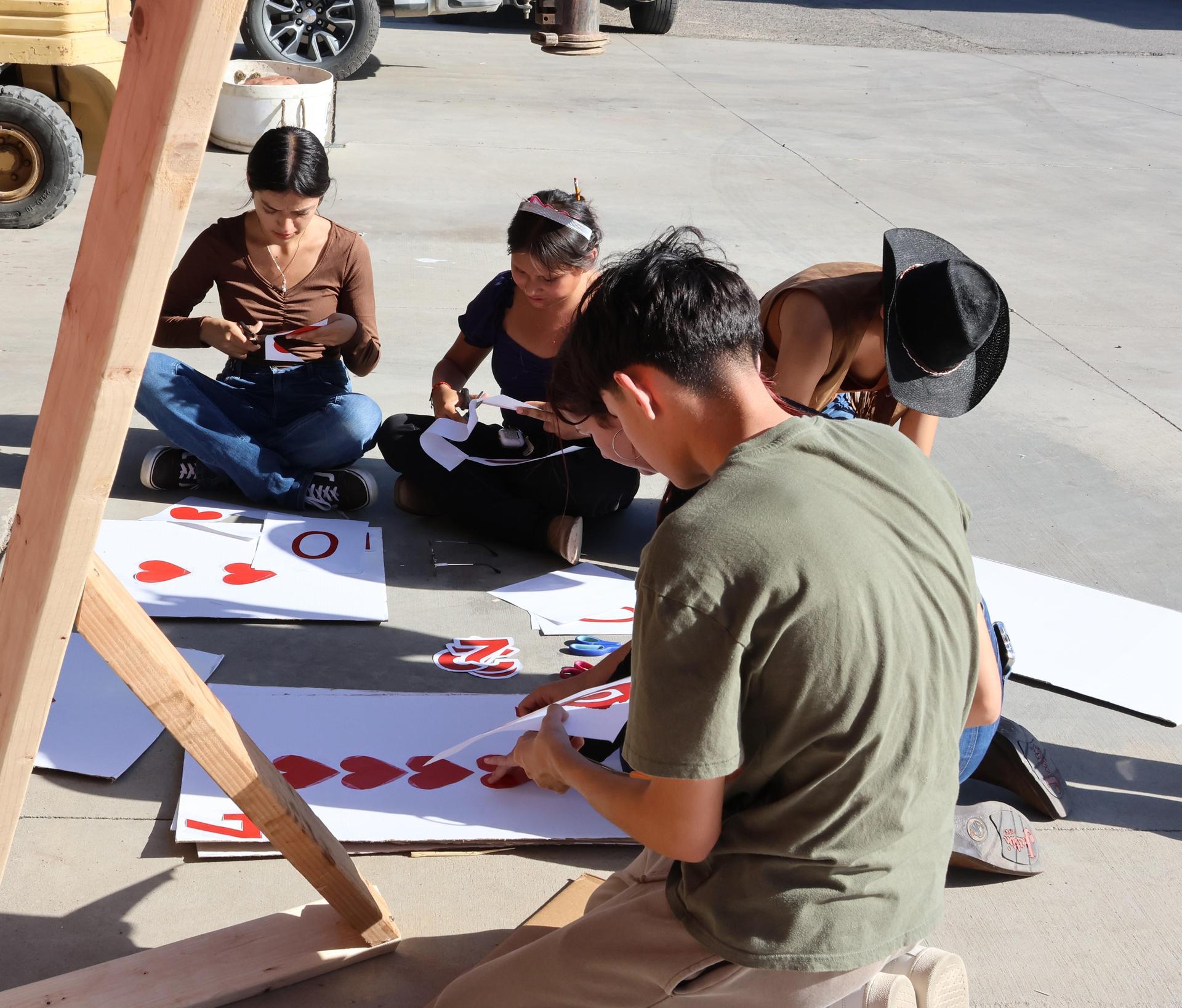 students, parents, and staff building floats for homecoming