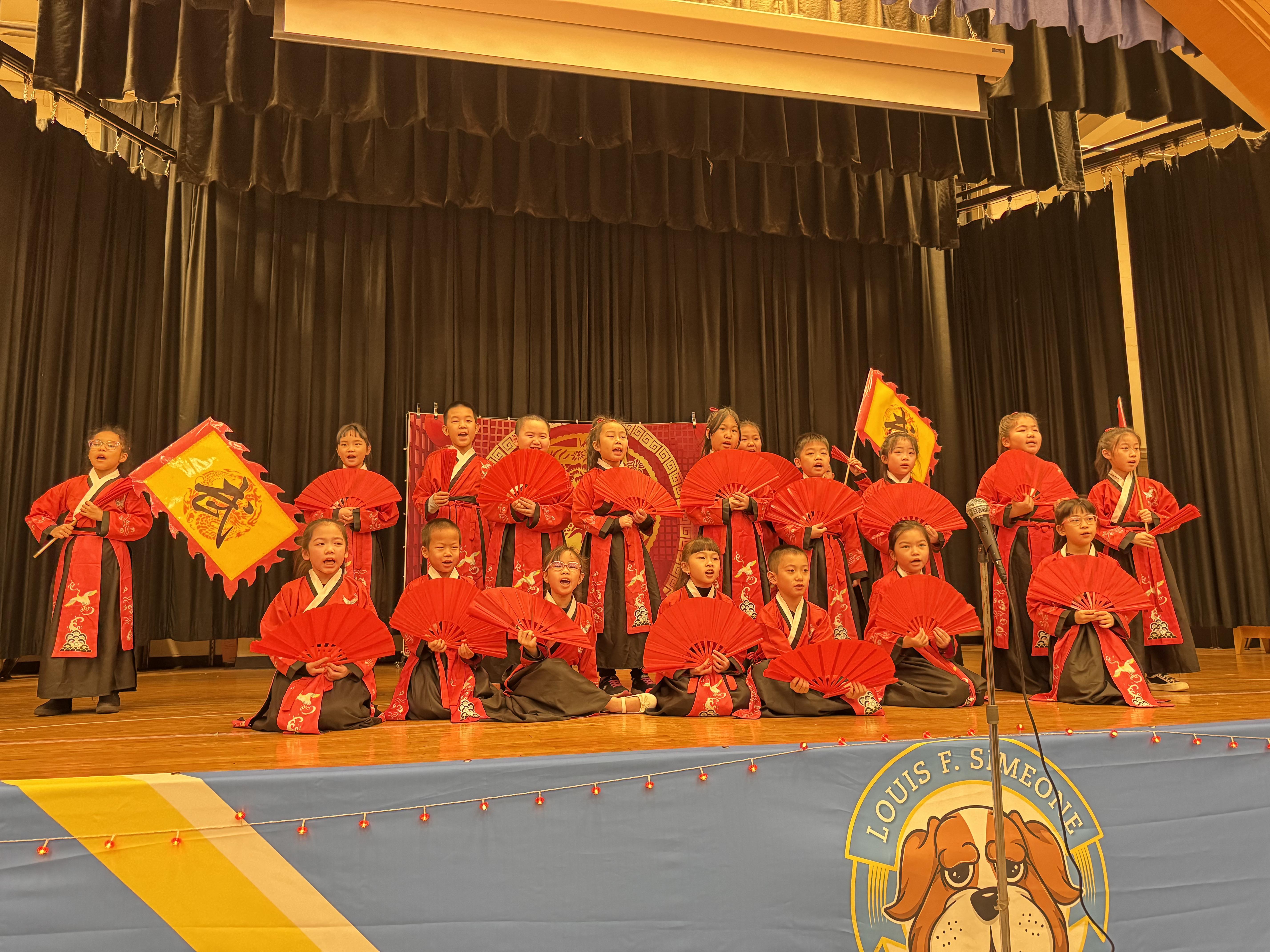 Students dressed in traditional Chinese clothing, red and black hanfu