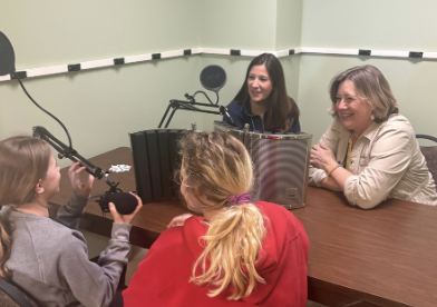 Students gaze at teacher as they interview