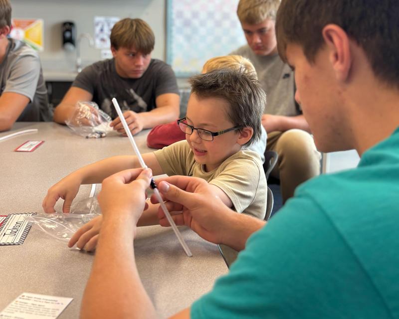 students making friendship bracelets
