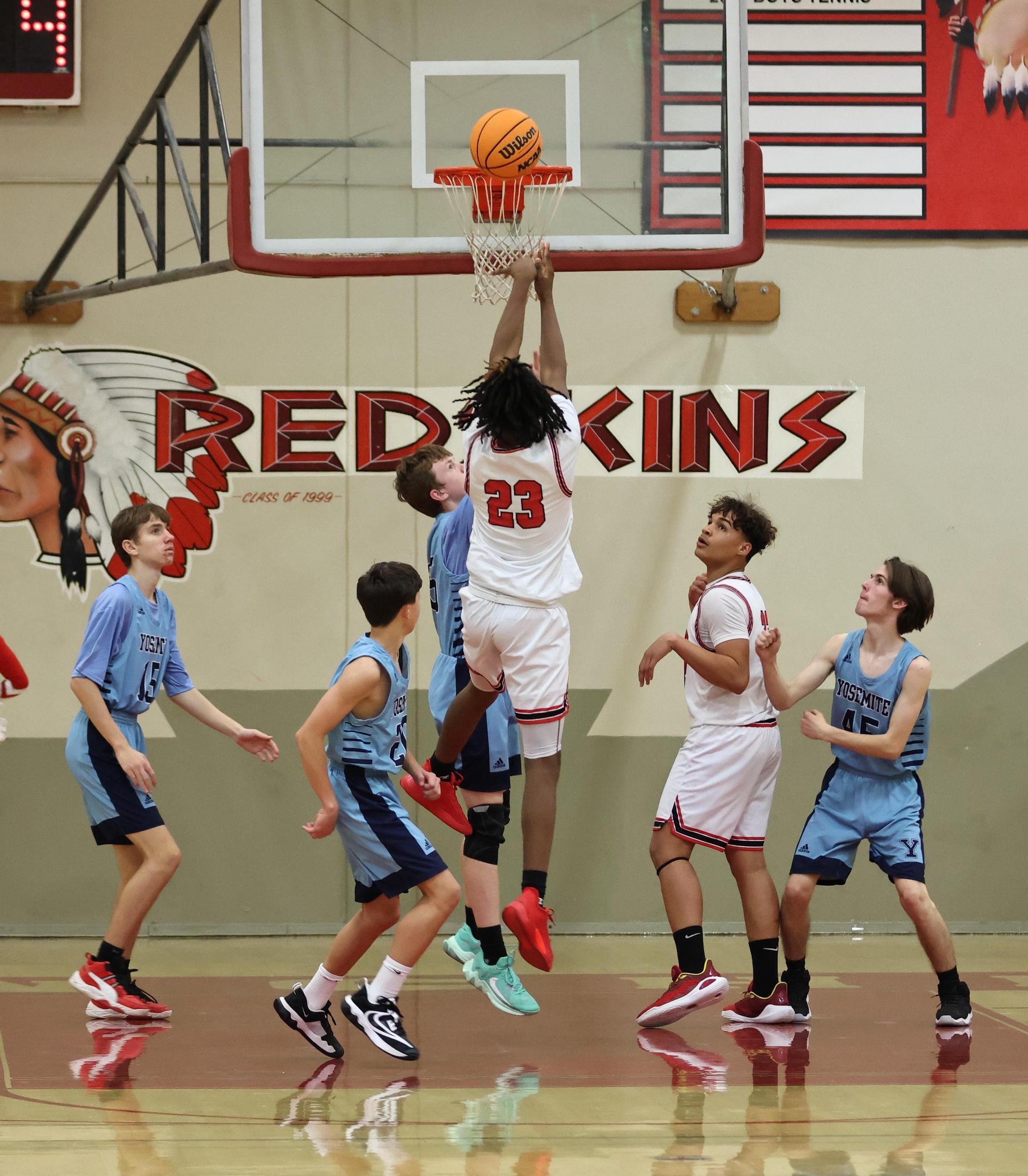 junior varsity boys playing basketball against yosemite