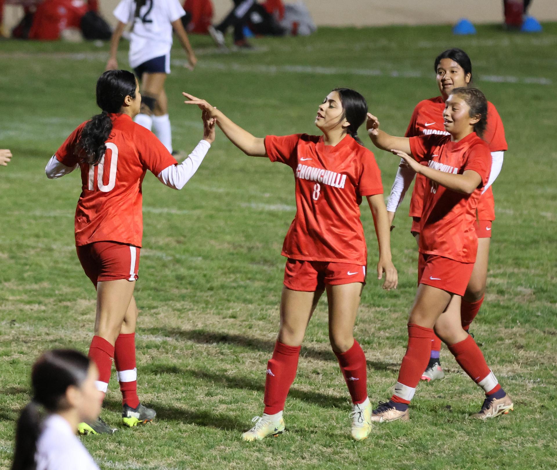 Varsity girls playing soccer against sunnyside