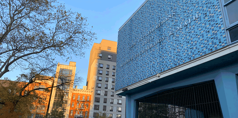 Exterior of NEST+m school building with blue mosaic tile.