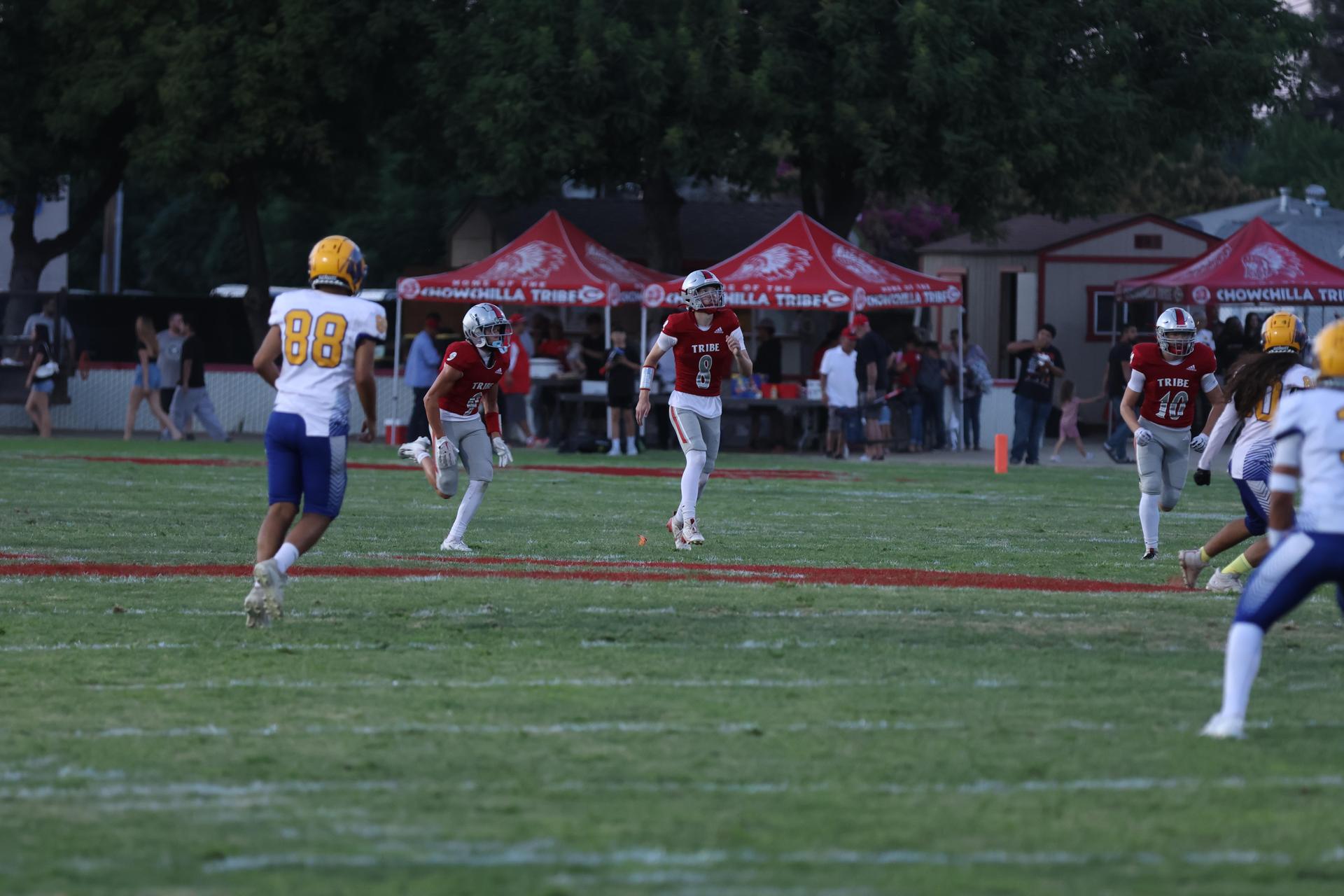 Varsity football players in action against Parlier 5