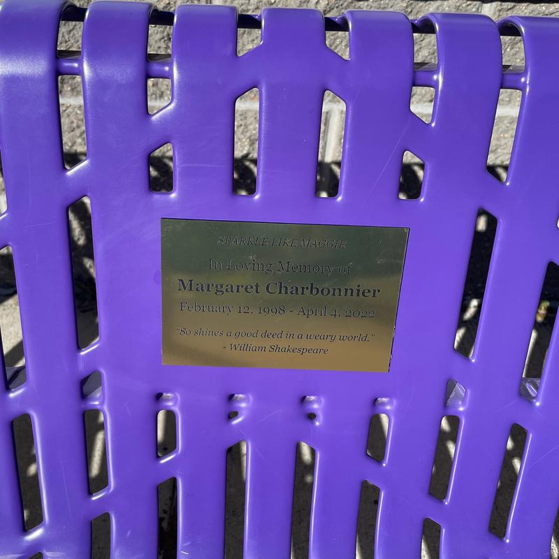 Purple bench with a memorial plaque for Margaret Charbonnier.