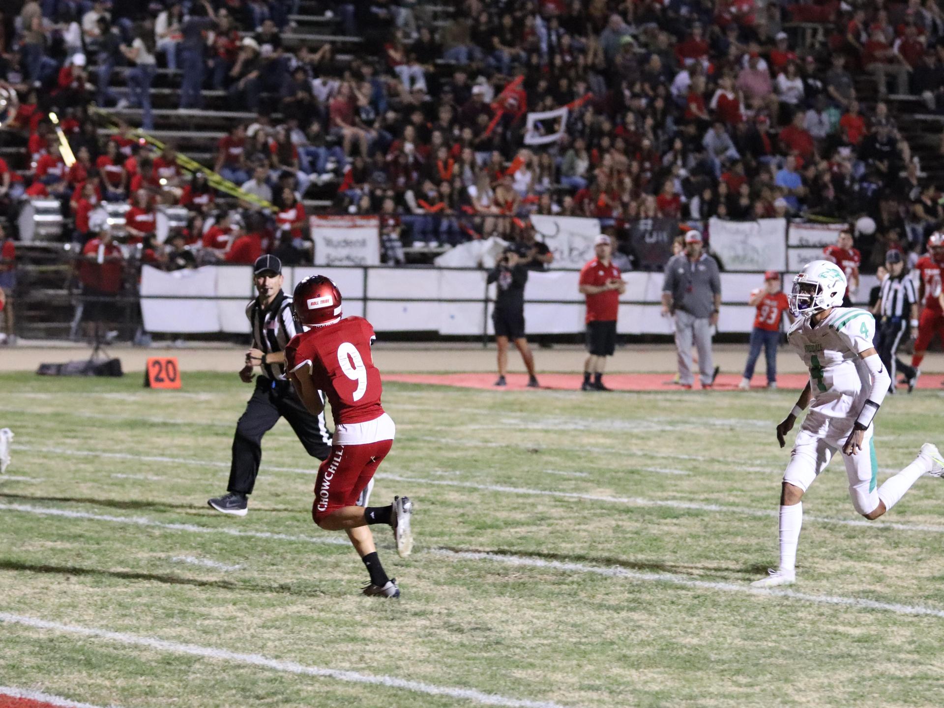 varsity football players in action against Riverdale