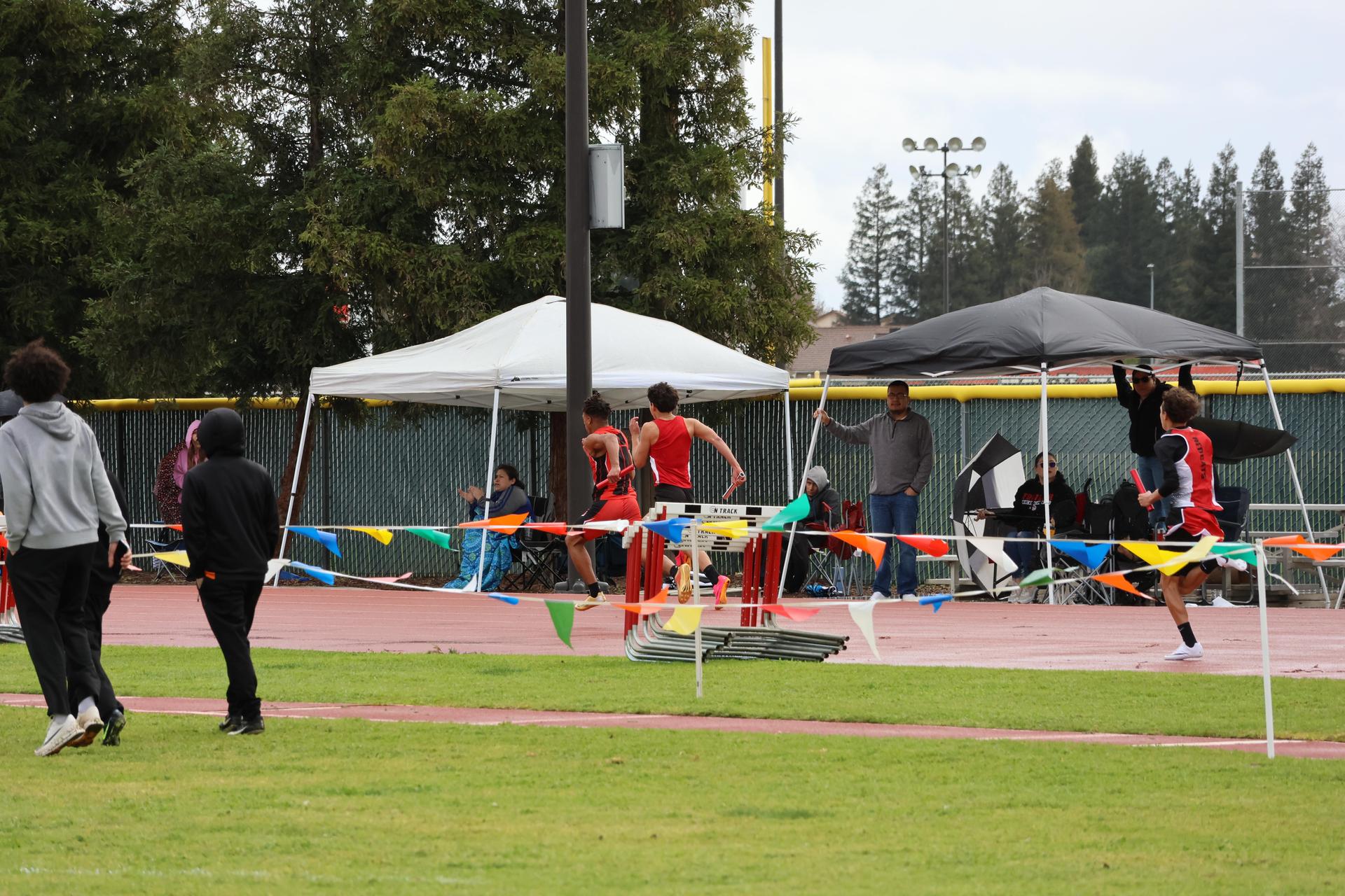 junior varsity boys running the four by 100 meter relay
