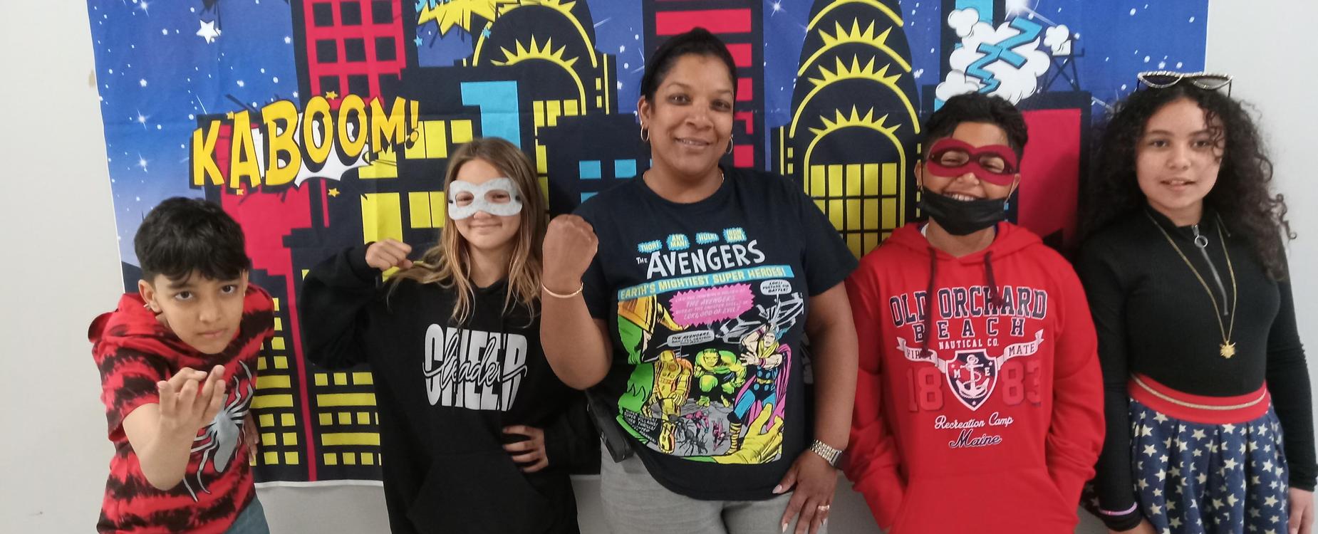 Students with the principal on super hero spirit day