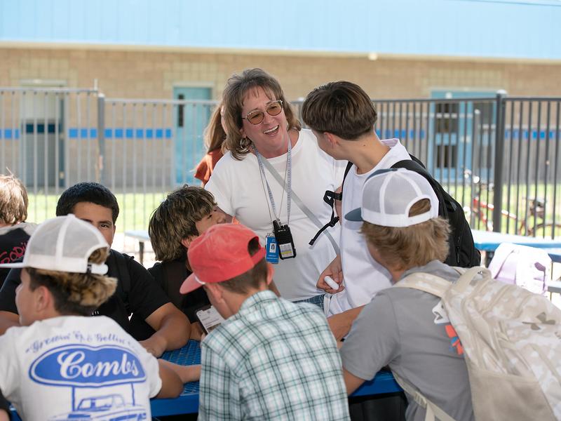 Principal conversing with students at lunch