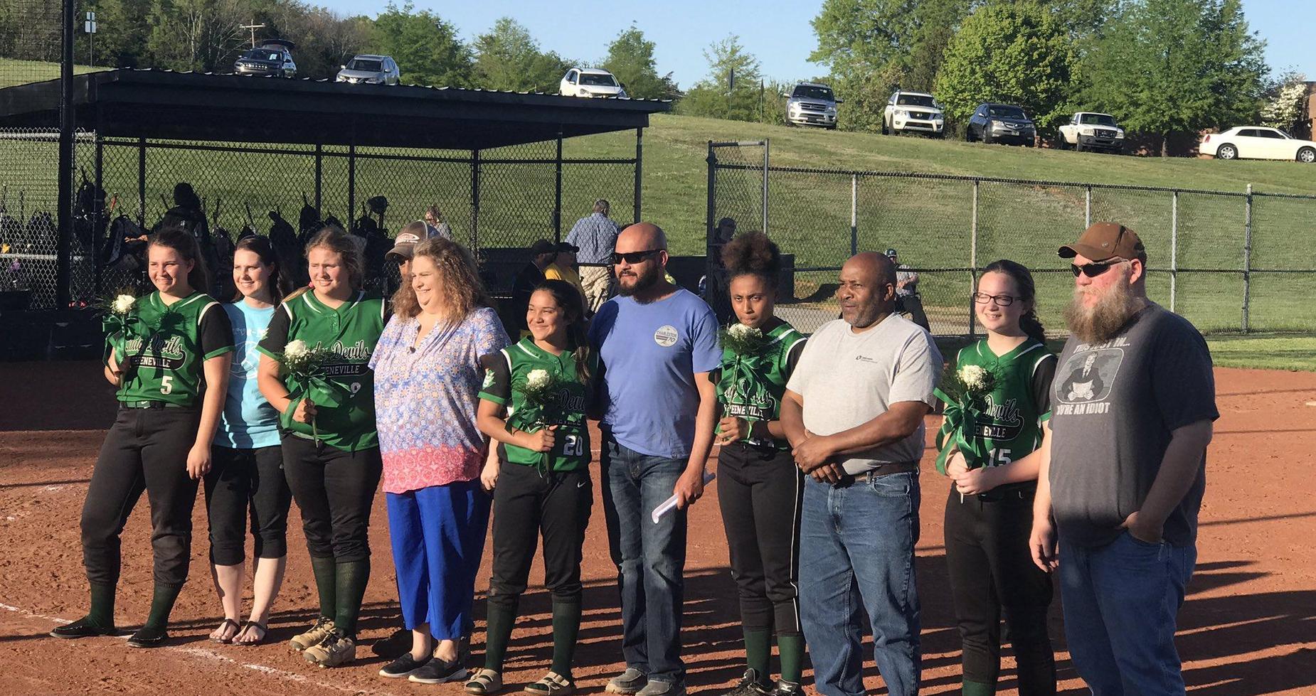 A picture of 8th grade softball players with parents